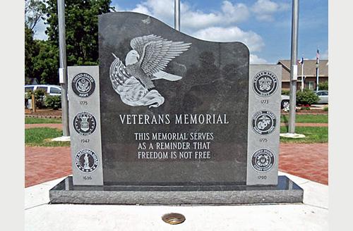 Walcott Main Veterans Memorial with etched bald eagle, US flag, and military seals