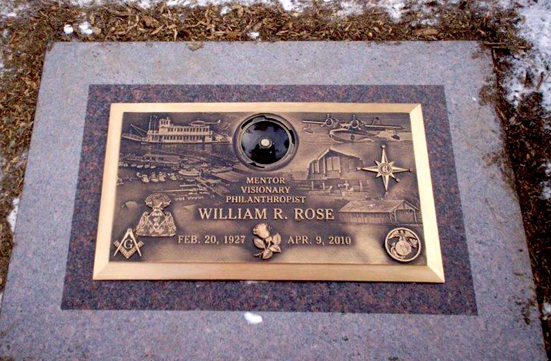Bronze photo montage marker with vase on colored granite base