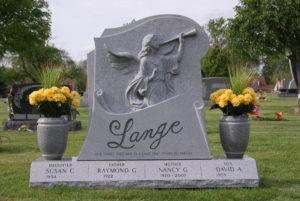 Grey granite family monument with raised carving of an angel