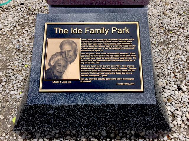 Bronze plaque with photo of couple mounted on granite pedestal
