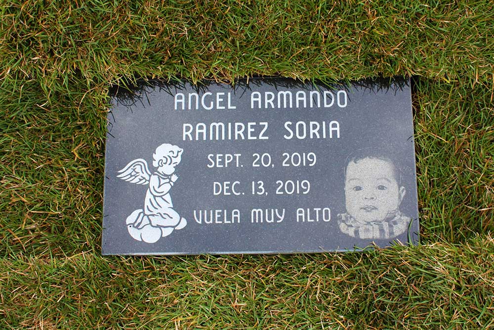 Child's marker with hand engraved portrait, angel carving, and Spanish lettering