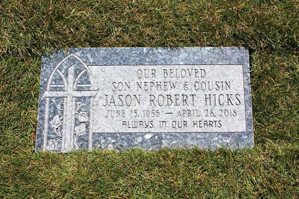 Blue granite marker with cross and ivy