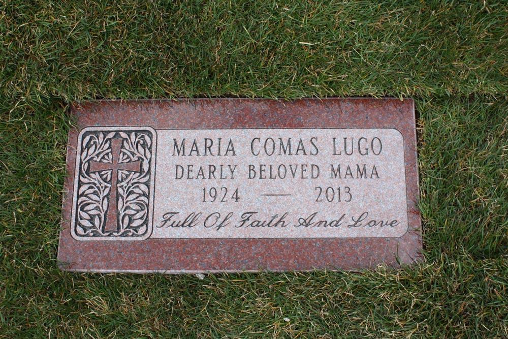 Red granite marker with cross and verse