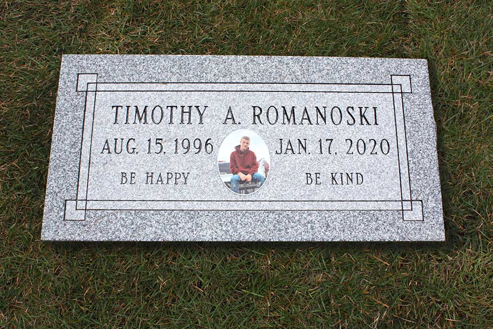 Grey granite marker with decorative panel and color ceramic photo