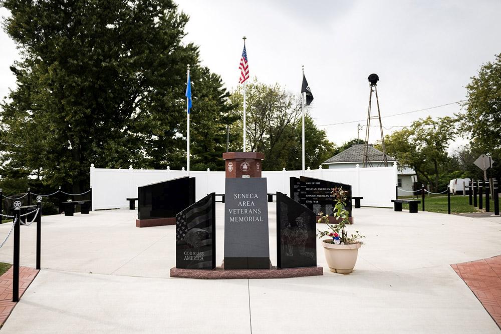 Seneca WI Veterans Memorial, medium shot of front view with black upright monuments in front of main memorial