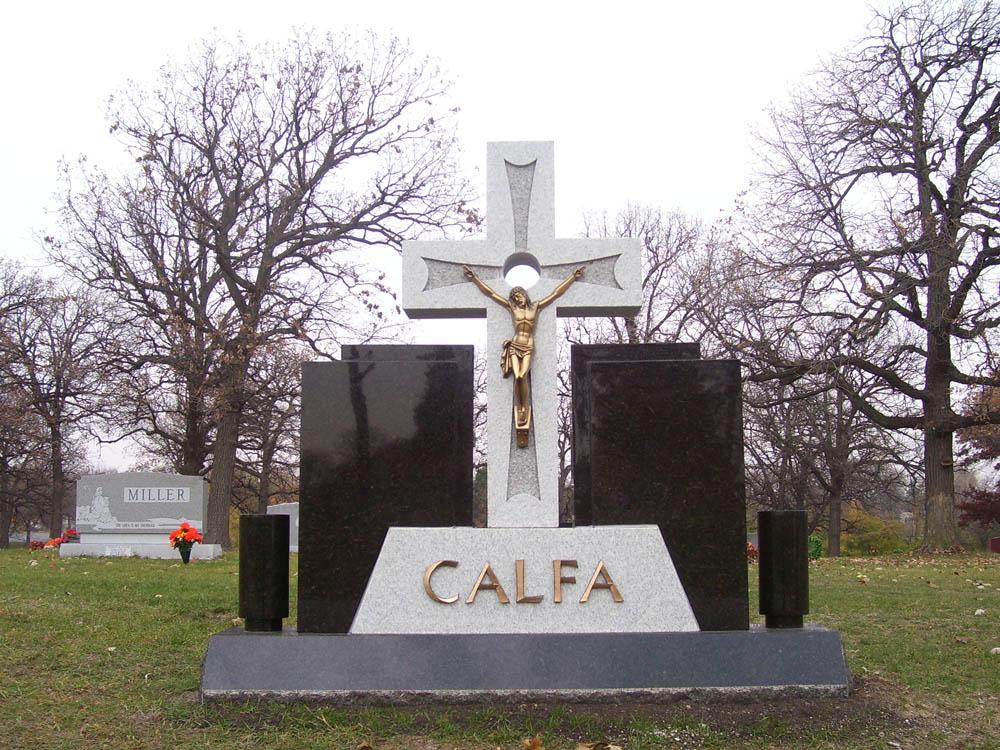 Black and gray granite family monument with a bronze corpus of Jesus
