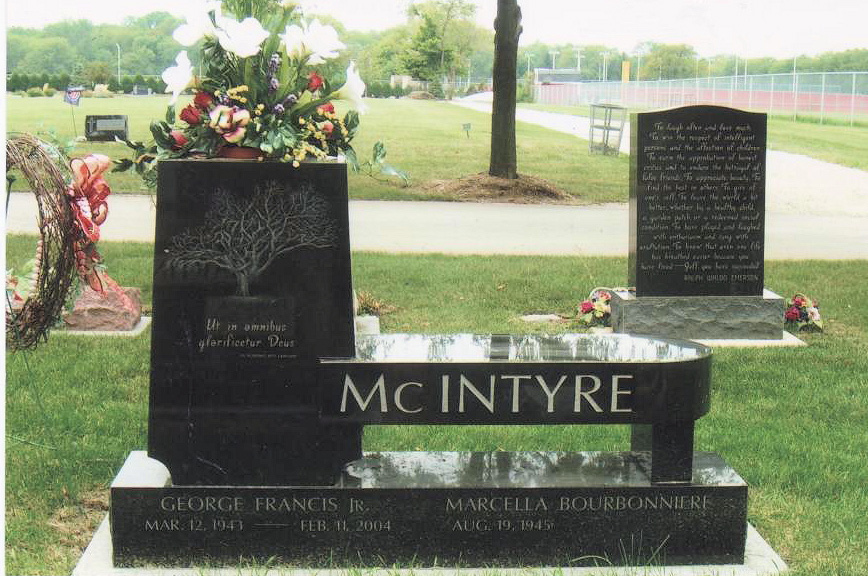 Black granite bench monument with etched tree and flower vase