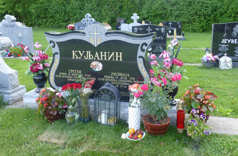 Family monument in black granite with gold painted Cyrillic lettering