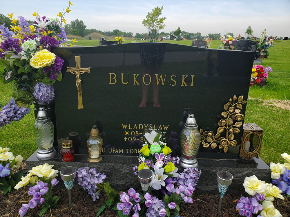 Family monument in black granite with gold painted letters and a Polish verse