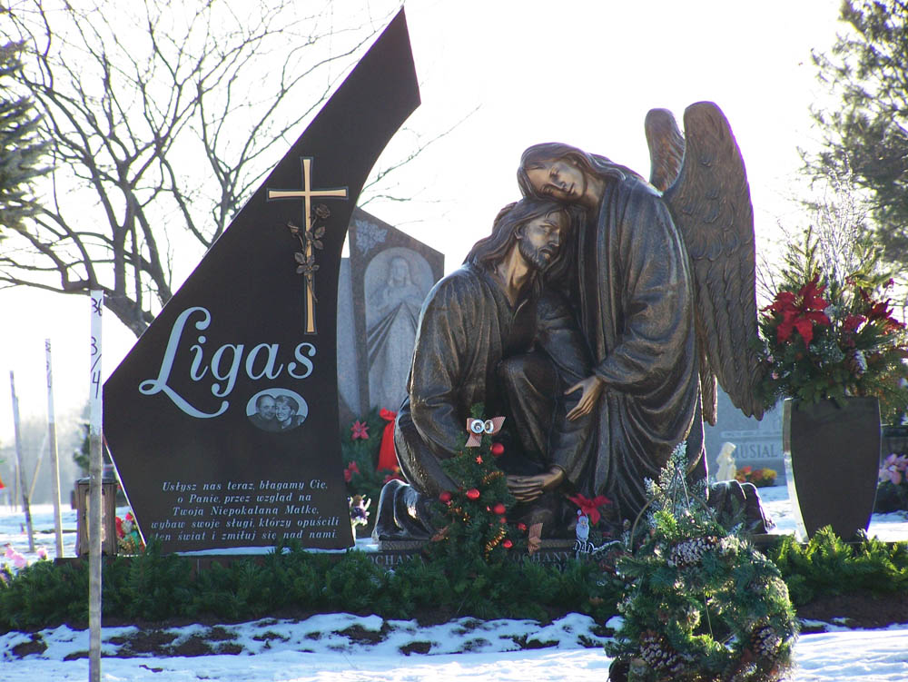 Family monument in black granite with Christian sculpture and a Polish verse