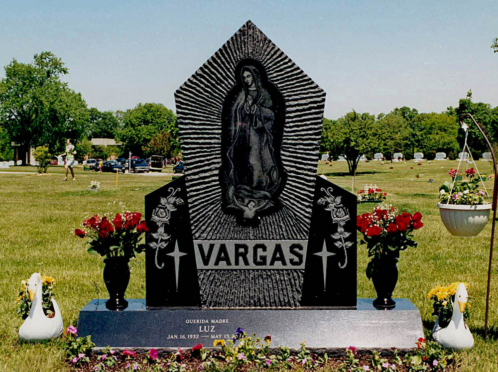Family monument in black granite with etching of Our Lady of Guadalupe