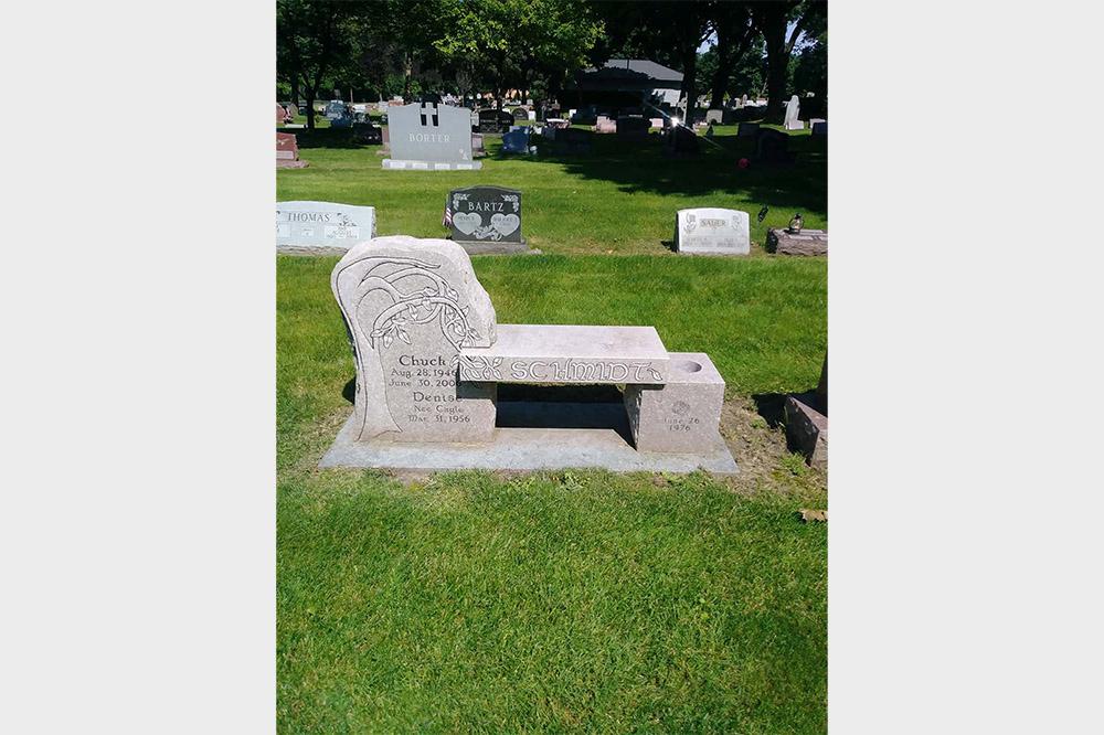 Grey granite bench monument with tree and wedding date