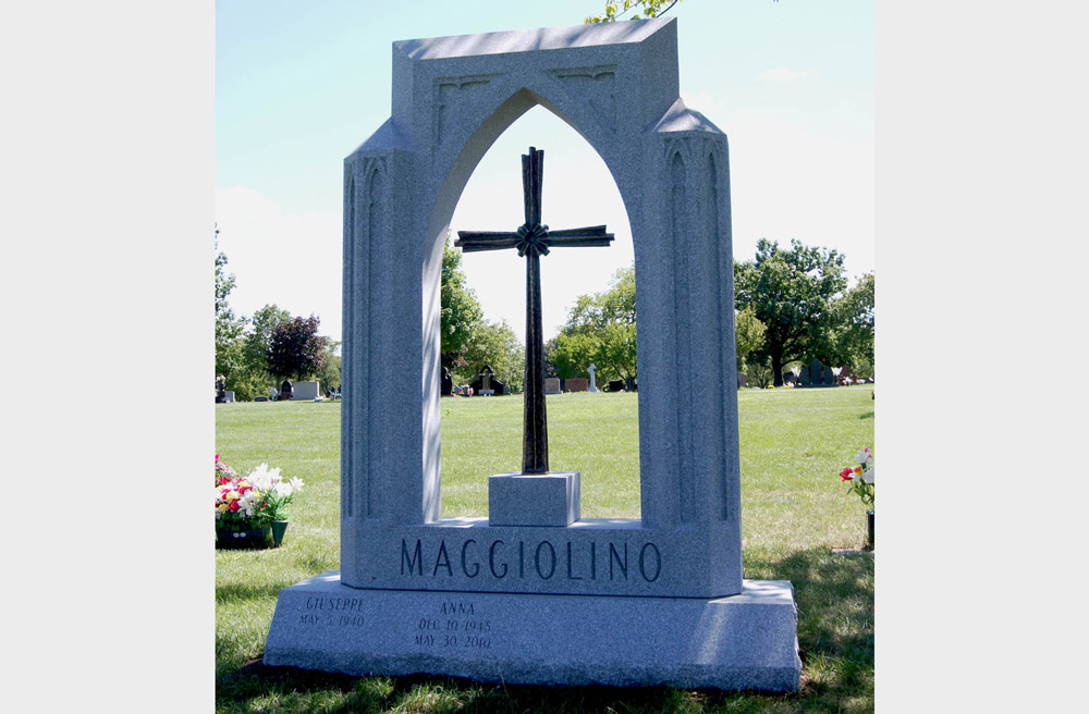 Family monument in grey granite with large bronze cross
