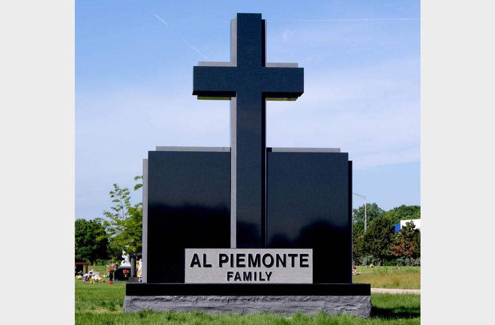 Large family monument in black granite with a Christian cross