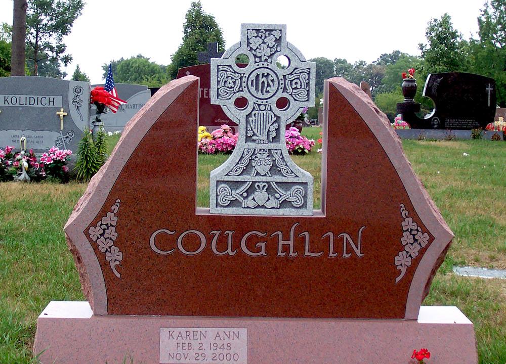 Red granite family monument with grey Celtic cross and shamrocks