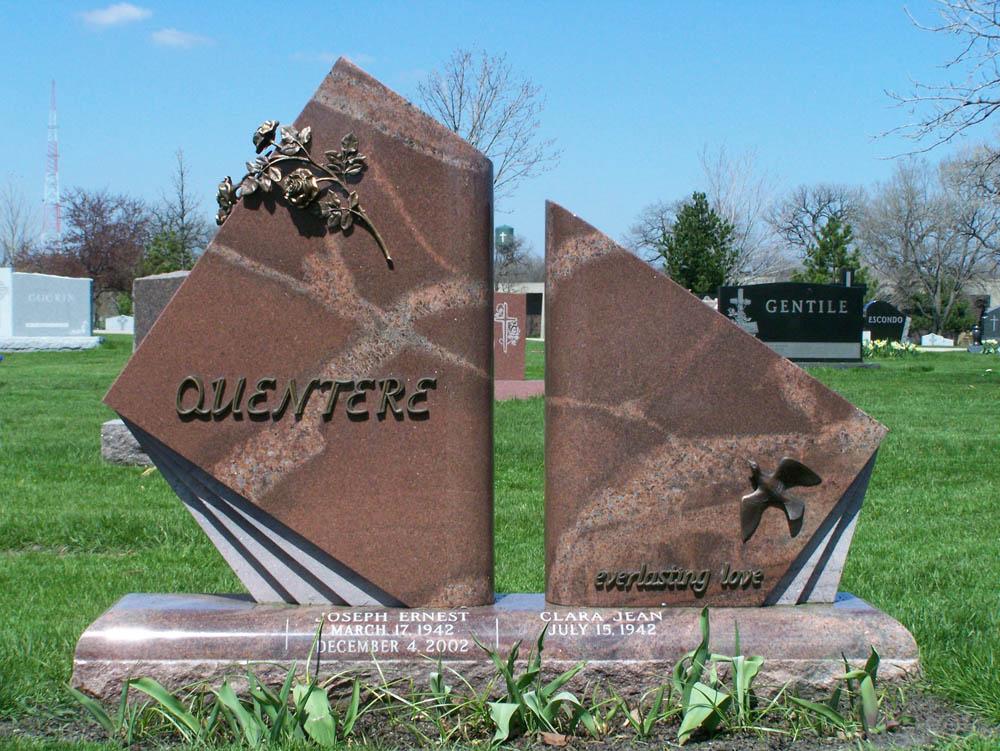 Family monument in variegated granite with roses, a dove, and bronze letters