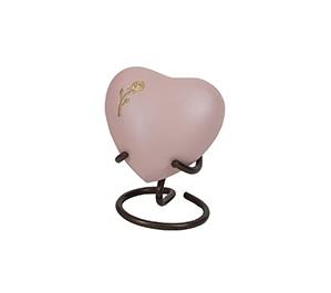 Small pink pastel heart shaped urn with bronze rose