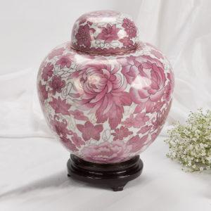 Round flower shaped pink and white urn with lid